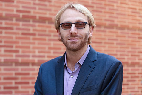 Portrait of Dino Di Carlo with a brick wall behind